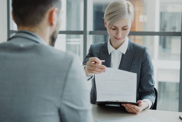Business professionals reviewing a technology vendor contract - Marinum Consulting Business professionals reviewing a technology vendor contract